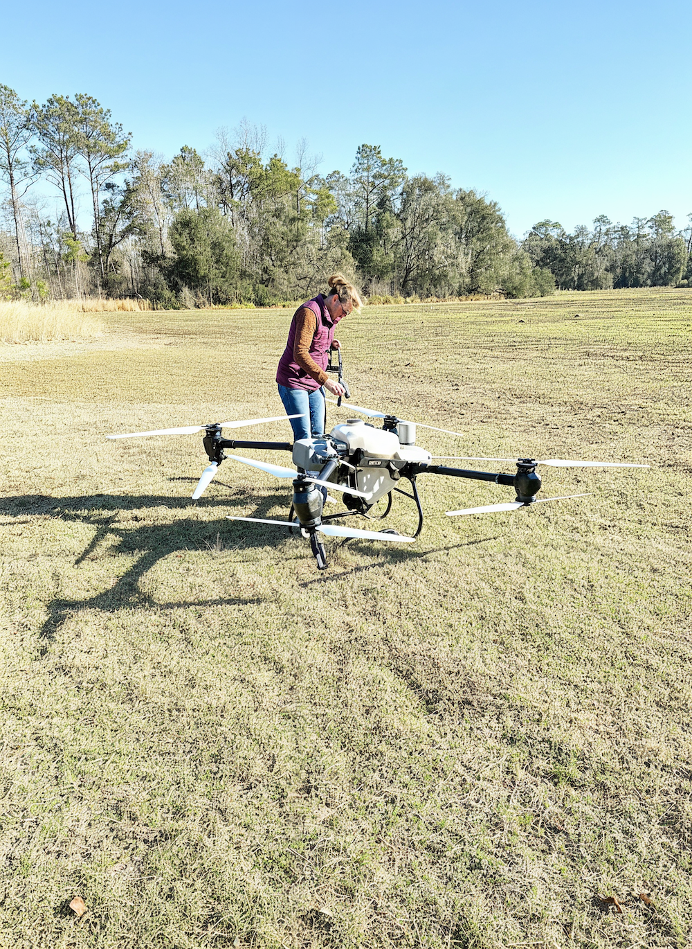 Amber Wilkinson with DJI T-50 drone in field